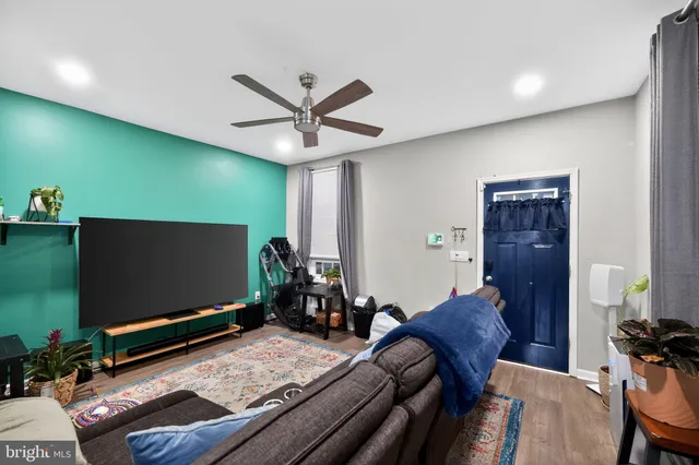 a bedroom with furniture and a flat screen tv