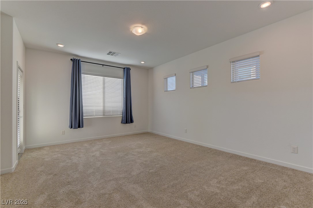727 Foreign Reef Way Las Vegas, NV 89138 - Photo 13 of 25 Empty room with light carpet and recessed lighting