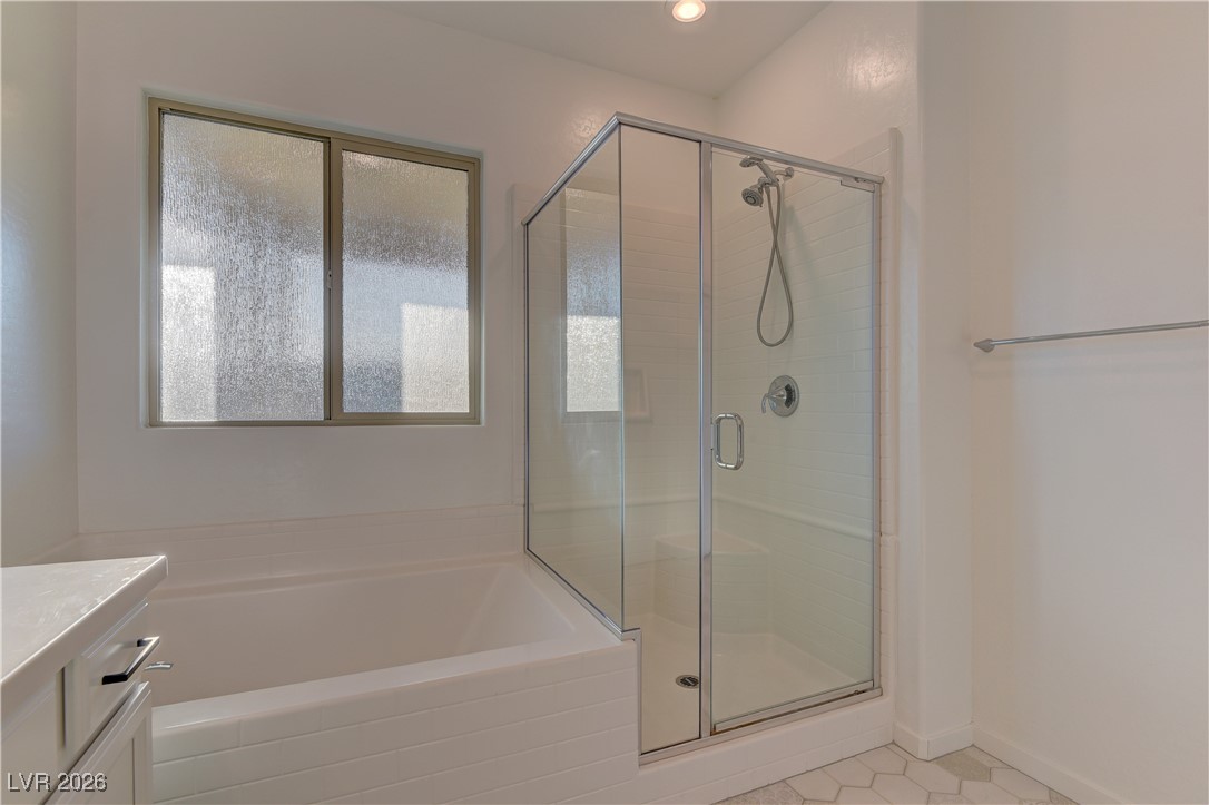 727 Foreign Reef Way Las Vegas, NV 89138 - Photo 19 of 25 Bathroom with vanity, a stall shower, and a bath