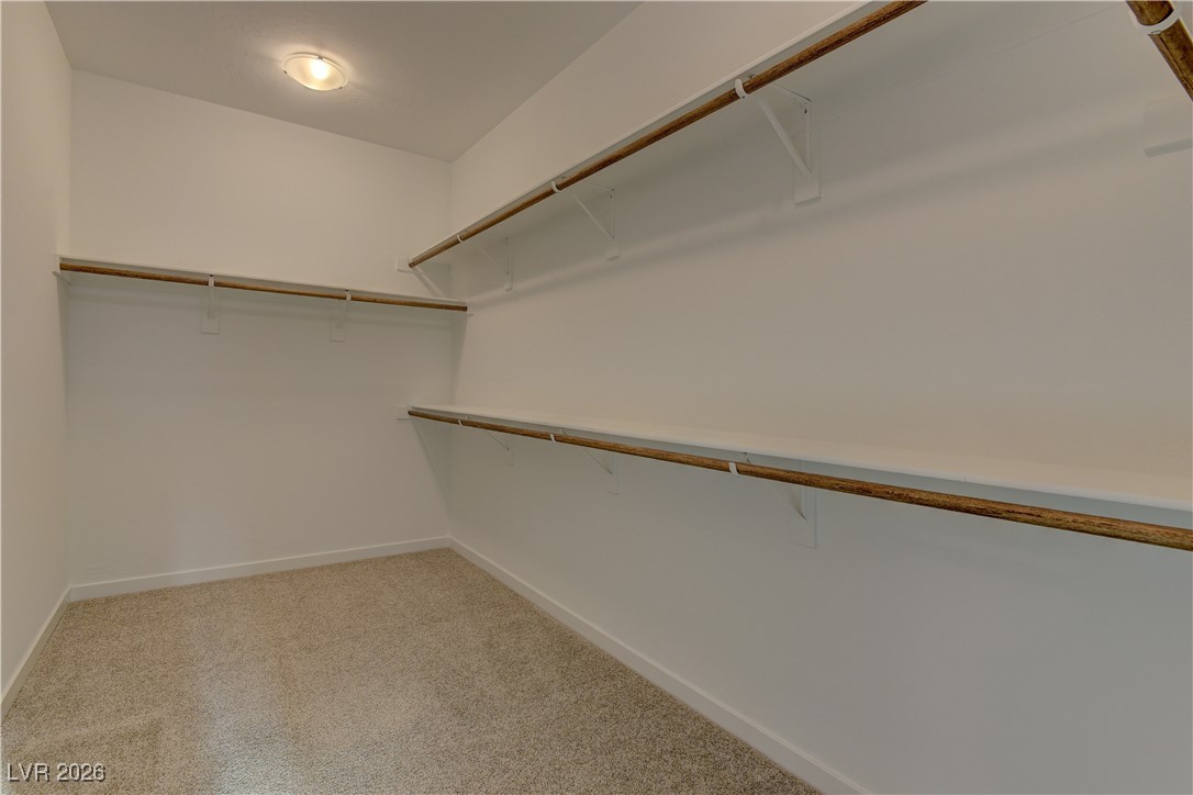 727 Foreign Reef Way Las Vegas, NV 89138 - Photo 20 of 25 Walk in closet featuring light colored carpet