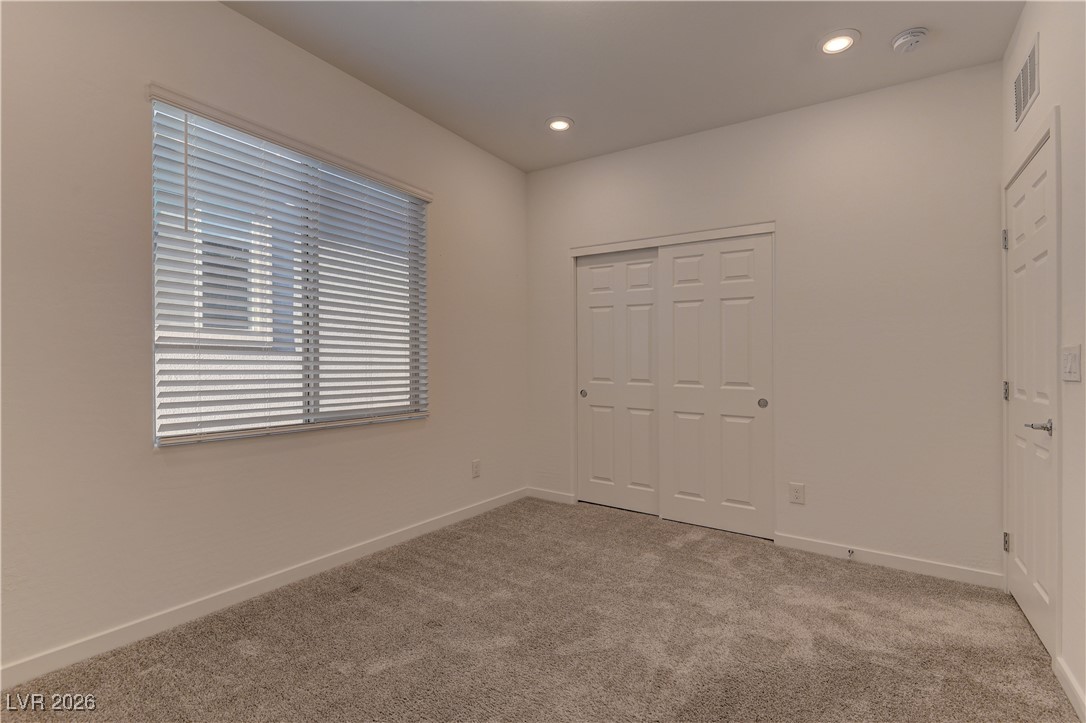 727 Foreign Reef Way Las Vegas, NV 89138 - Photo 22 of 25 Unfurnished bedroom featuring light colored carpet, recessed lighting, and a closet