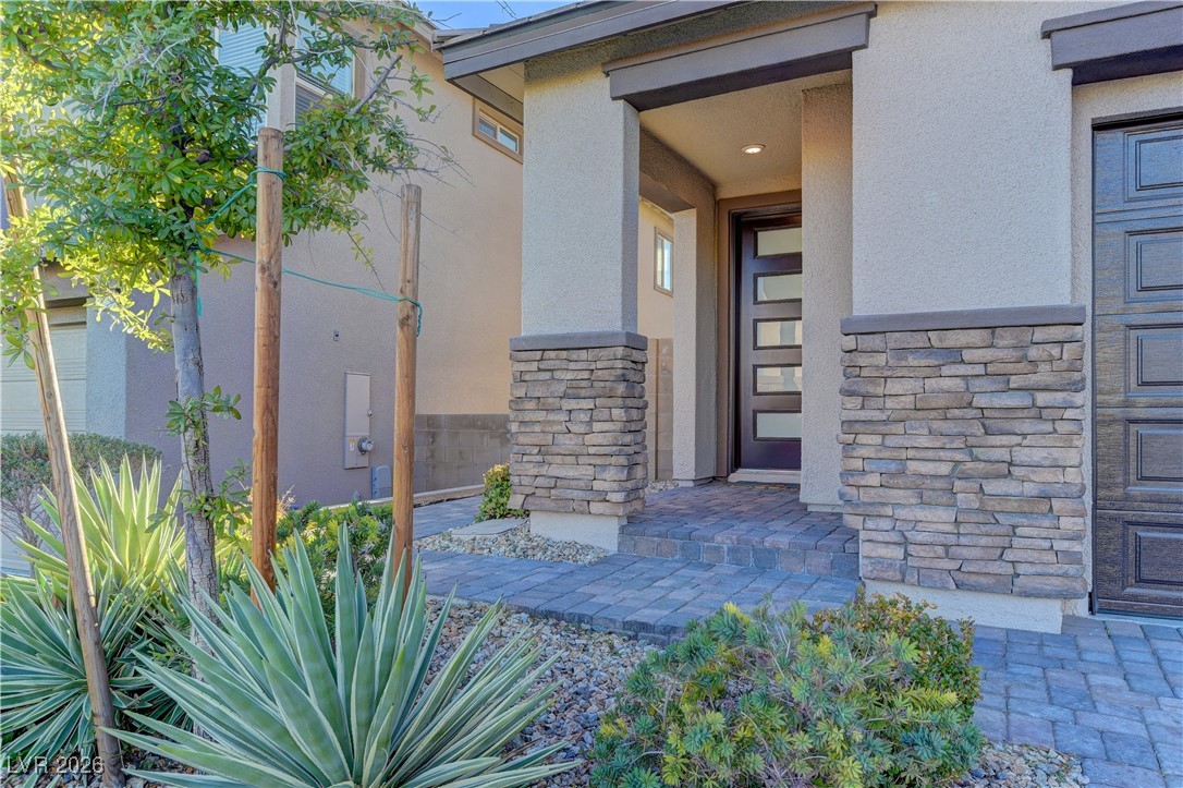 727 Foreign Reef Way Las Vegas, NV 89138 - Photo 3 of 25 Doorway to property with stone siding and stucco siding