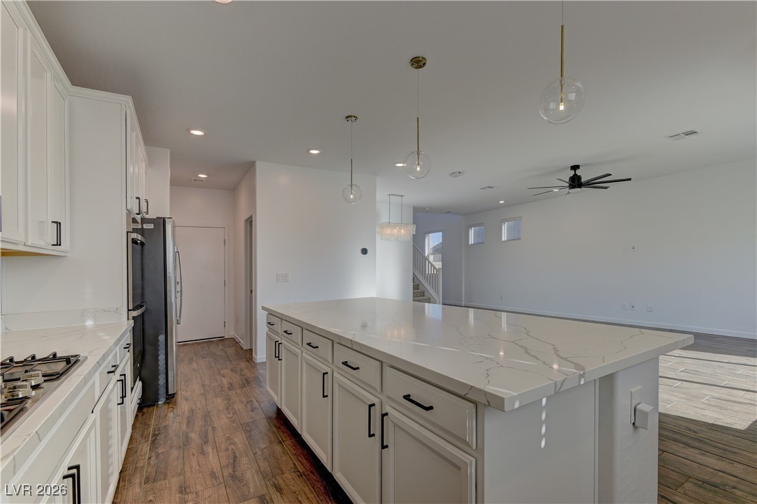727 Foreign Reef Way Las Vegas, NV 89138 - Photo 8 of 25 Kitchen with white cabinetry, ceiling fan, a kitchen island, decorative light fixtures, and recessed lighting
