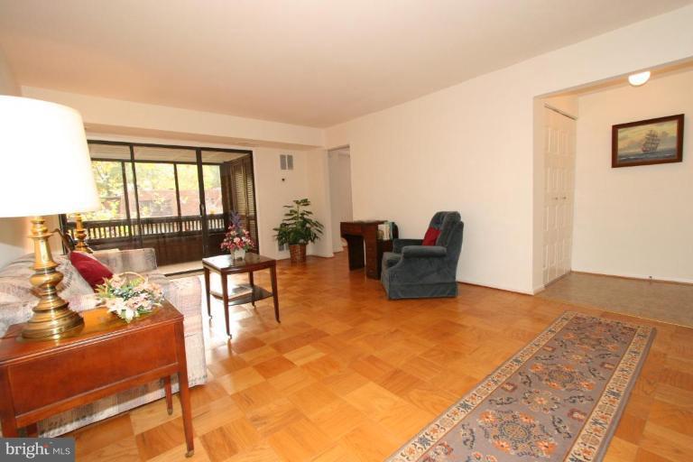 5235 West Running Brook Road, Unit 301 Columbia, MD 21044 - Photo 5 of 22 a living room with furniture and a floor to ceiling window
