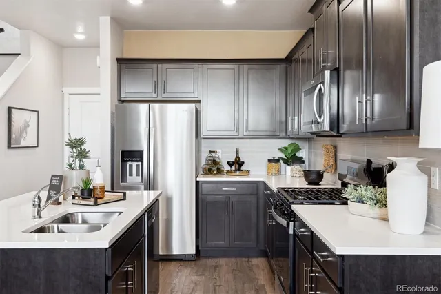 a kitchen with a sink a refrigerator and cabinets