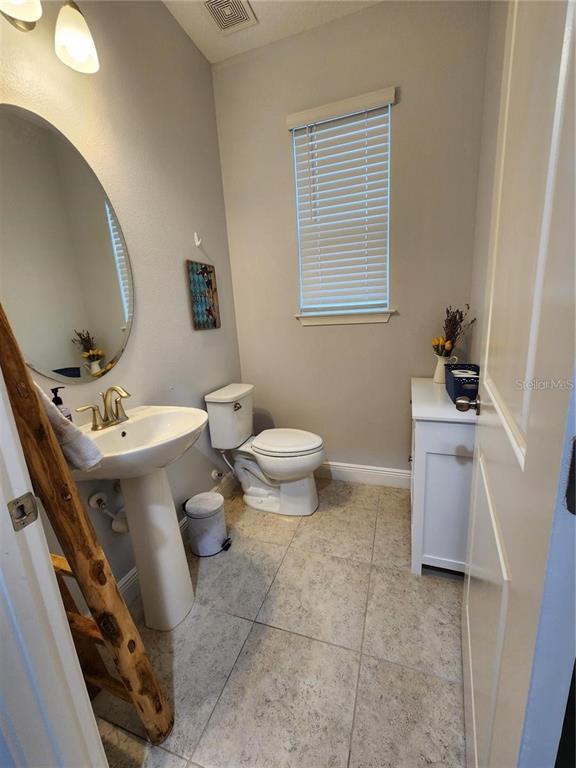 5514 Viola Lee Way Lutz, FL 33558 - Photo 12 of 17 a bathroom with a sink toilet and a mirror
