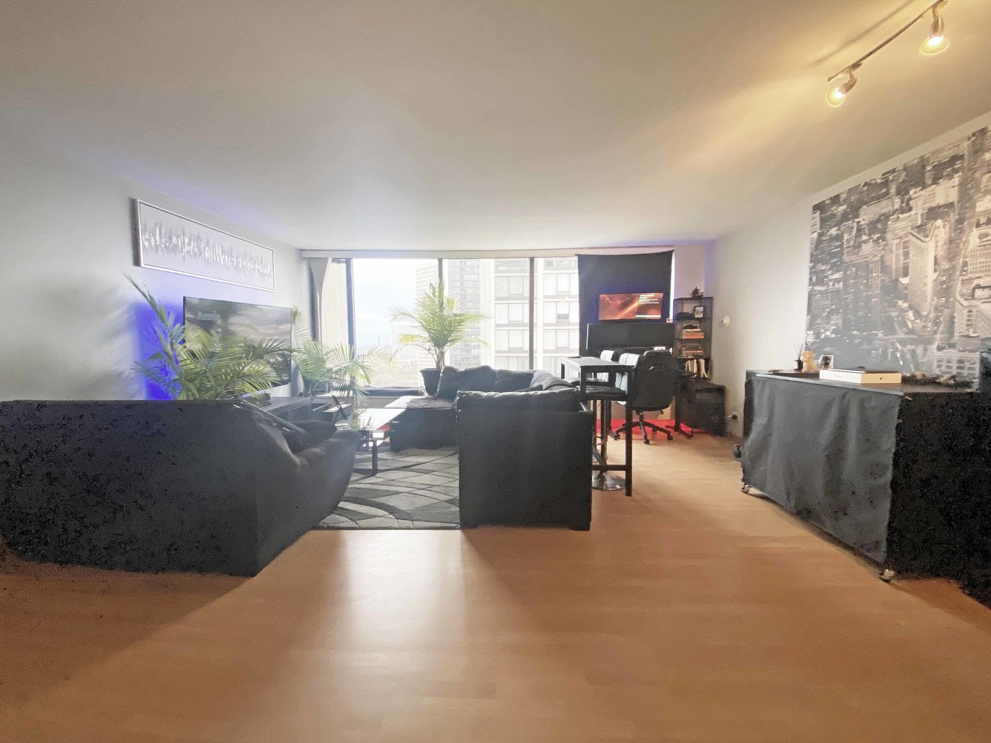 5455 North Sheridan Road, Unit 1708 Chicago, IL 60640 - Photo 3 of 20 a living room with furniture and a flat screen tv