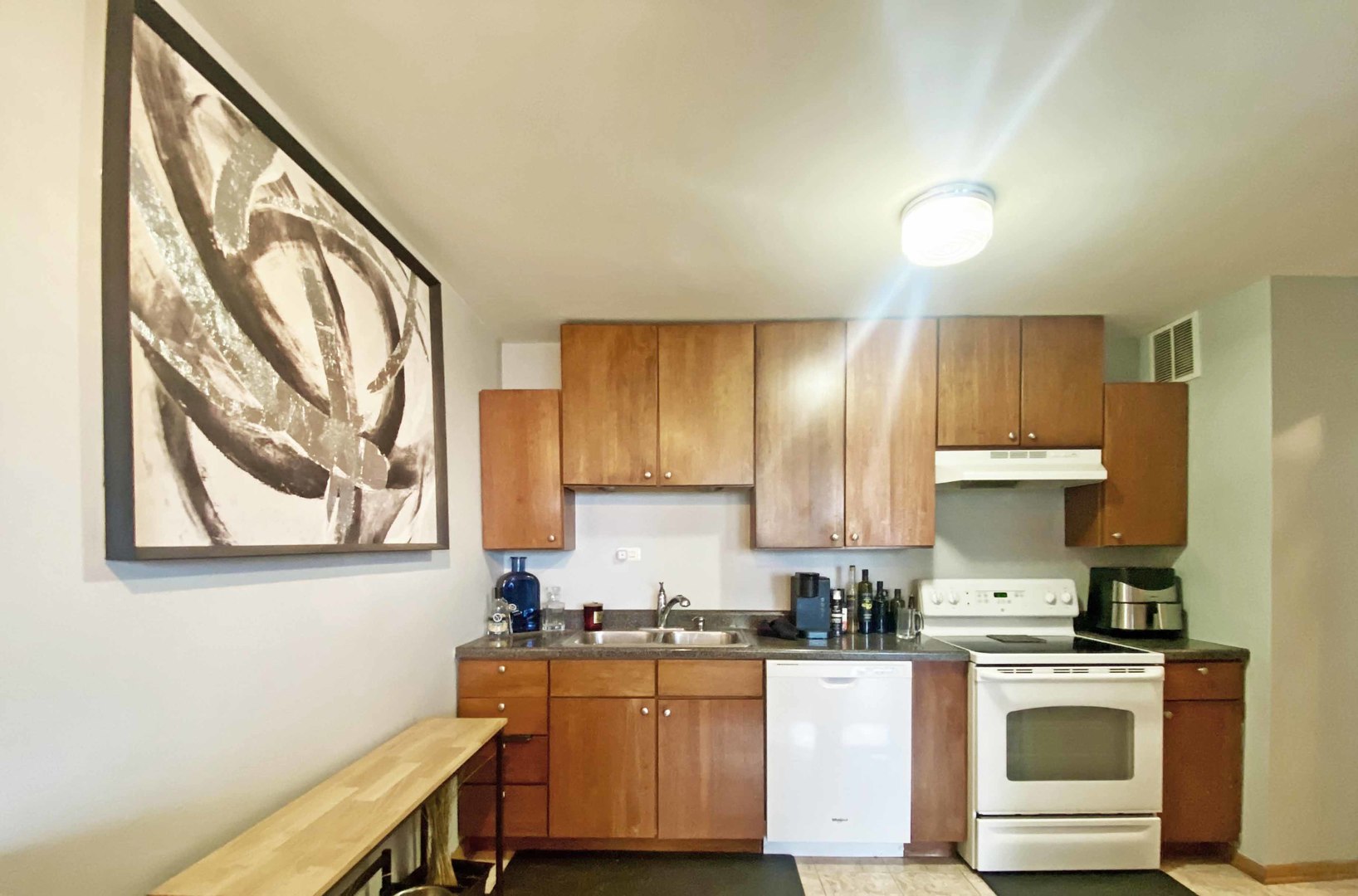 5455 North Sheridan Road, Unit 1708 Chicago, IL 60640 - Photo 4 of 20 a kitchen with stainless steel appliances granite countertop a stove a sink and a microwave