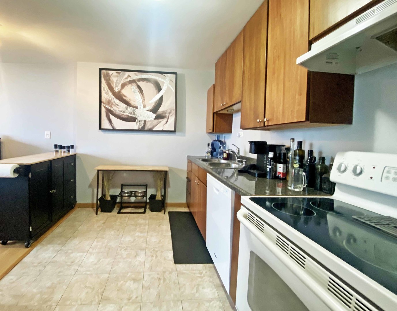 5455 North Sheridan Road, Unit 1708 Chicago, IL 60640 - Photo 5 of 20 a kitchen with stainless steel appliances a stove a sink and a microwave