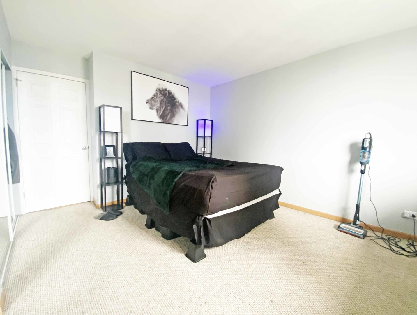5455 North Sheridan Road, Unit 1708 Chicago, IL 60640 - Photo 8 of 20 a living room with a bed and a table