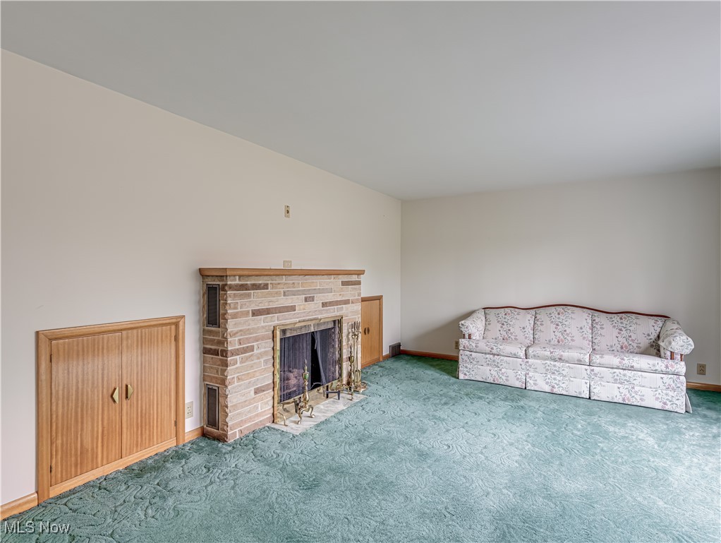 6576 State Road Wadsworth, OH 44281 - Photo 5 of 34 Unfurnished living room featuring carpet flooring and a fireplace