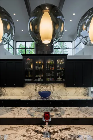 a kitchen with kitchen island granite countertop stainless steel appliances stove a sink and a microwave