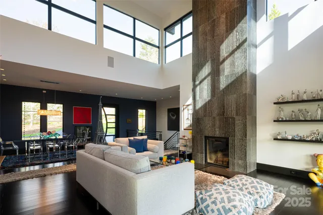 a living room with fireplace and a mirror