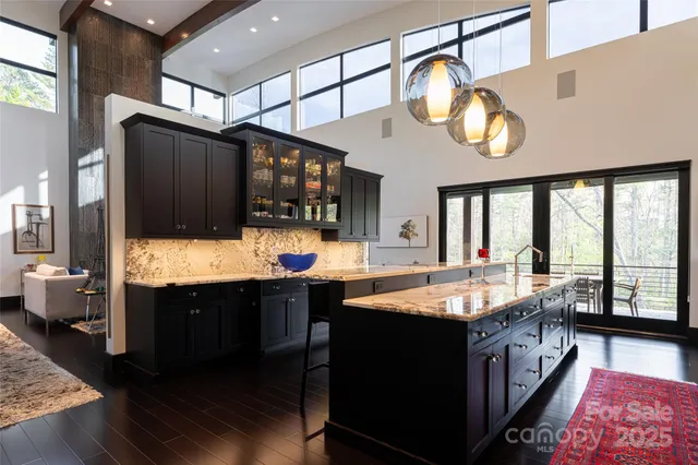 a large kitchen with stainless steel appliances double vanity and a stove