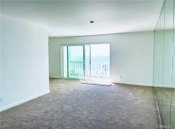 an empty room with an empty space and windows