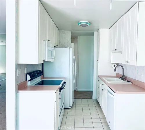 a kitchen with a sink a stove and refrigerator