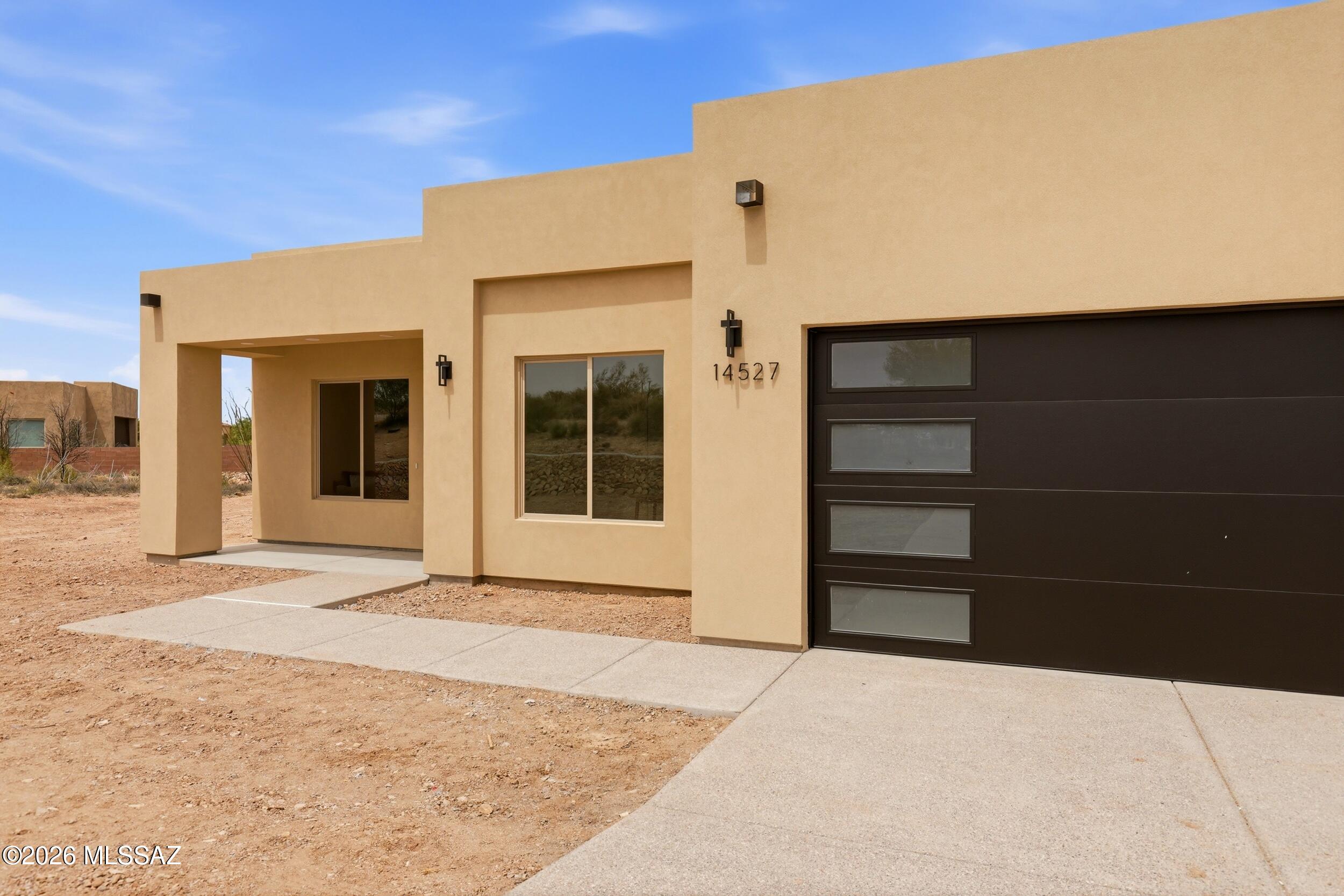 14527 East Sands Ranch Road Vail, AZ 85641 - Photo 4 of 48 a front view of a house with a yard