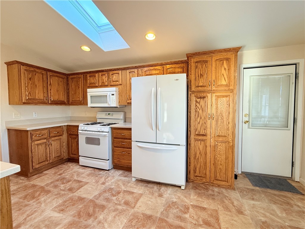 2350 Adobe Road Road, Unit 191 Bullhead City, AZ 86442 - Photo 11 of 52 a kitchen with a refrigerator sink and cabinets