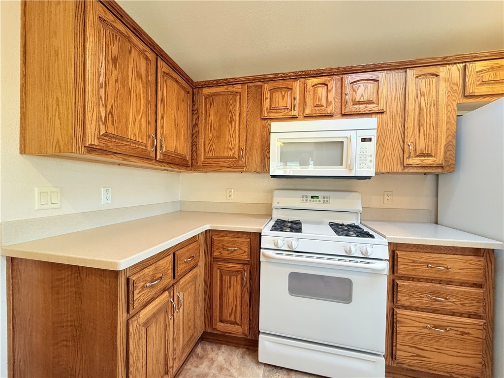 2350 Adobe Road Road, Unit 191 Bullhead City, AZ 86442 - Photo 14 of 52 a kitchen with stainless steel appliances granite countertop white cabinets sink and a granite counter top