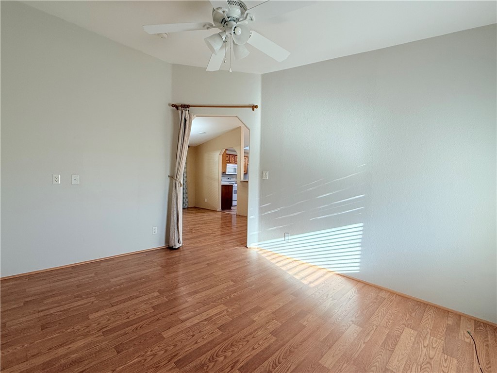 2350 Adobe Road Road, Unit 191 Bullhead City, AZ 86442 - Photo 19 of 52 an empty room with wooden floor fan and windows