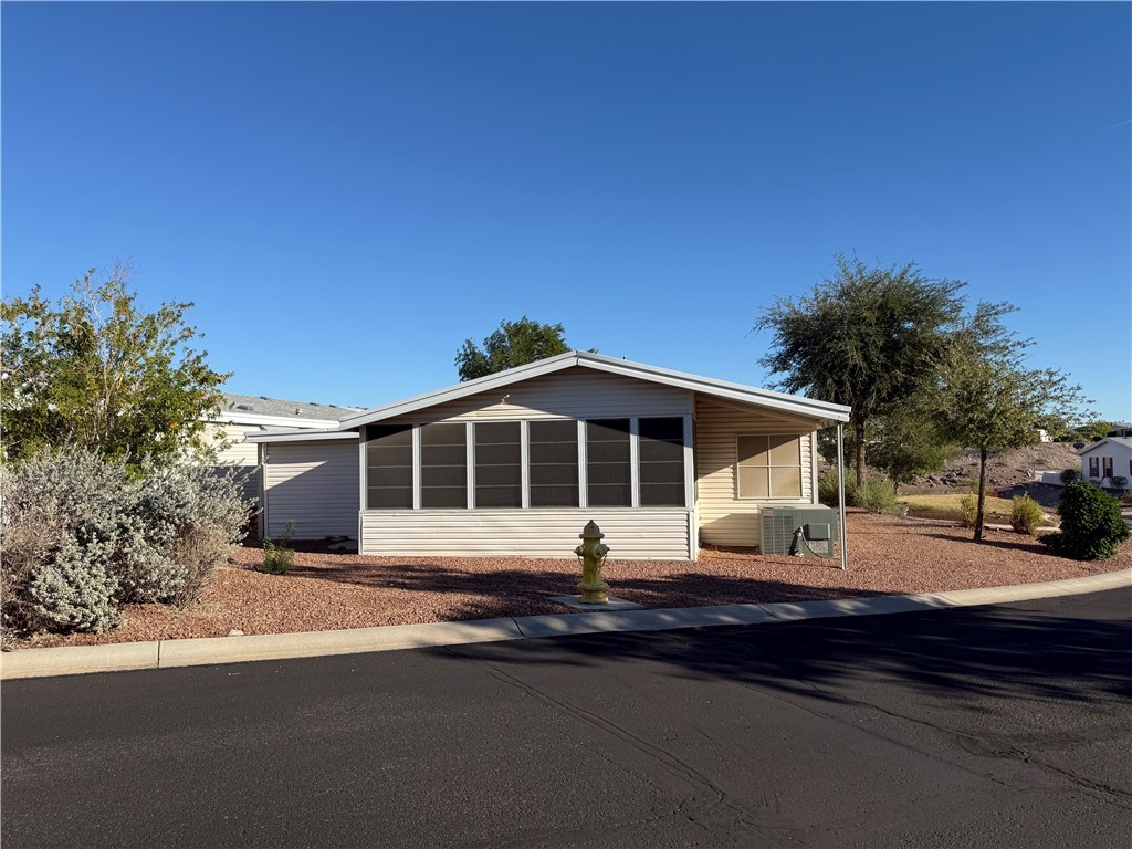 2350 Adobe Road Road, Unit 191 Bullhead City, AZ 86442 - Photo 2 of 52 a front view of a house with a yard