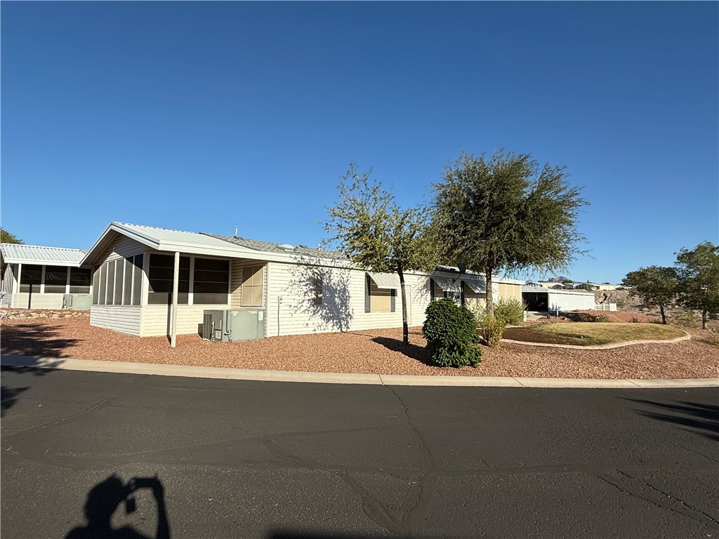 2350 Adobe Road Road, Unit 191 Bullhead City, AZ 86442 - Photo 3 of 52 a front view of a house with a yard