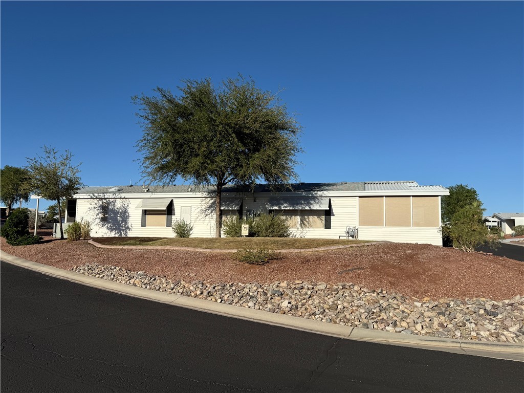 2350 Adobe Road Road, Unit 191 Bullhead City, AZ 86442 - Photo 4 of 52 a front view of a house with a yard and garage