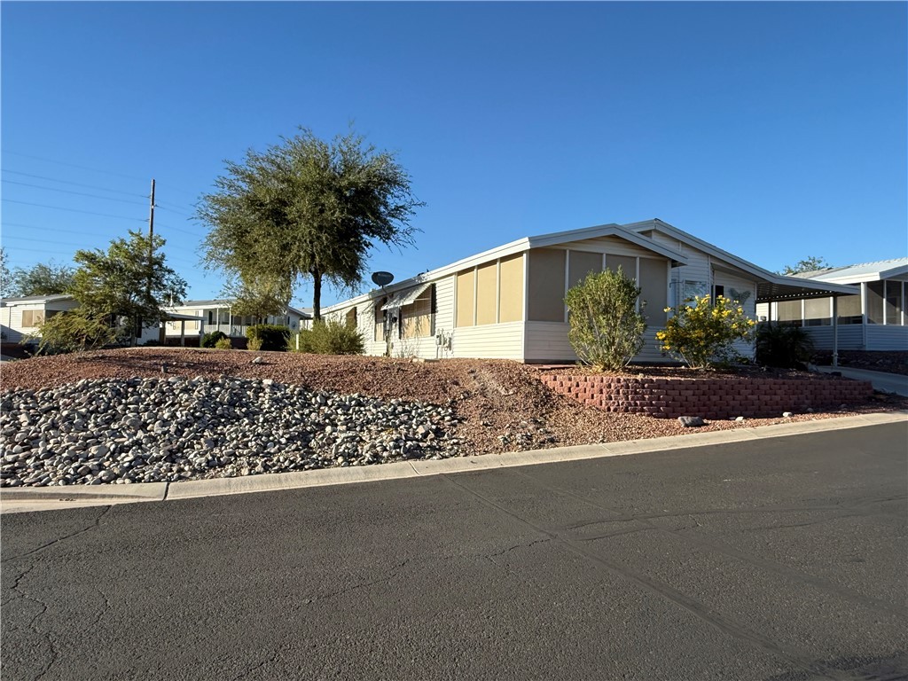 2350 Adobe Road Road, Unit 191 Bullhead City, AZ 86442 - Photo 5 of 52 a front view of a house with a yard
