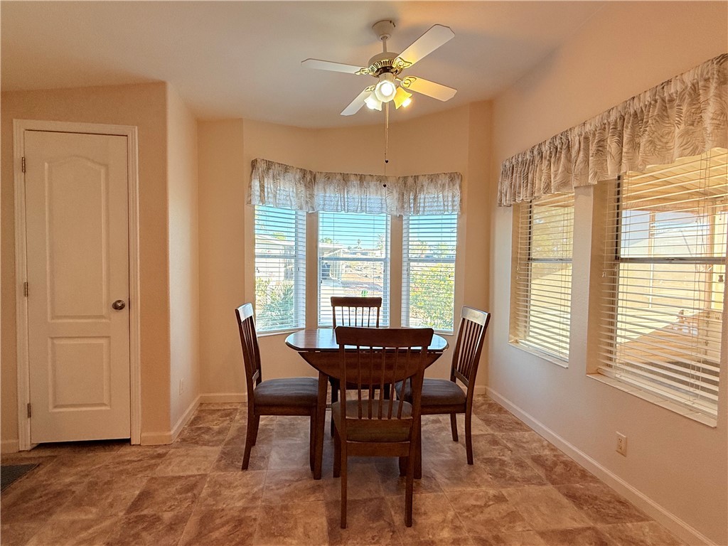 2350 Adobe Road Road, Unit 191 Bullhead City, AZ 86442 - Photo 7 of 52 a dining room with furniture a chandelier and a rug