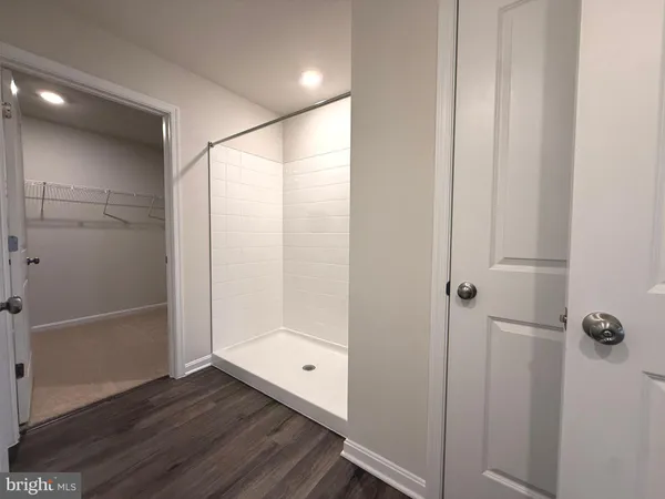 a bathroom with a glass shower door