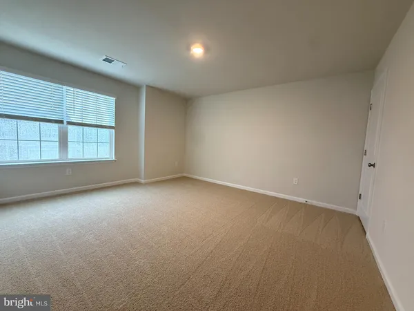 an empty room with a empty space and windows