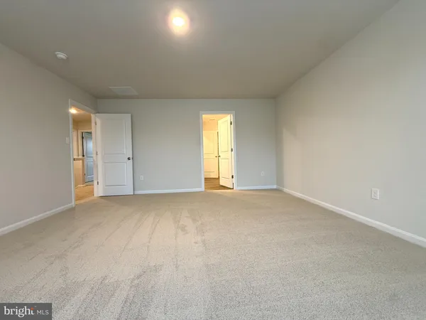 an empty room with a windows and closet