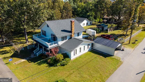 an aerial view of a house with swimming pool and porch