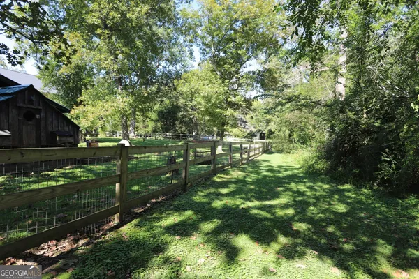 a view of a house with backyard sitting area and garden