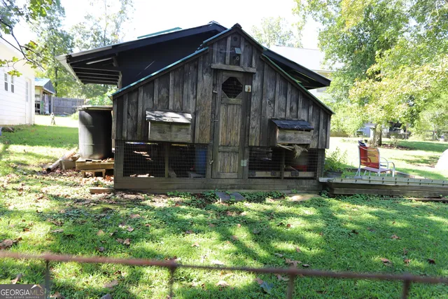 a view of a house with backyard and a patio