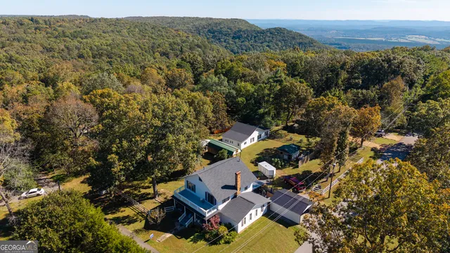 an aerial view of a house with a yard