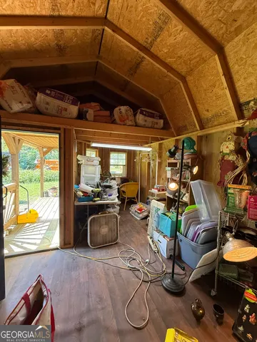 a view of a room with gym equipment and large windows