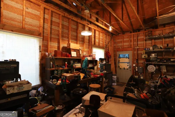 a living room with stainless steel appliances kitchen island granite countertop furniture and a fireplace