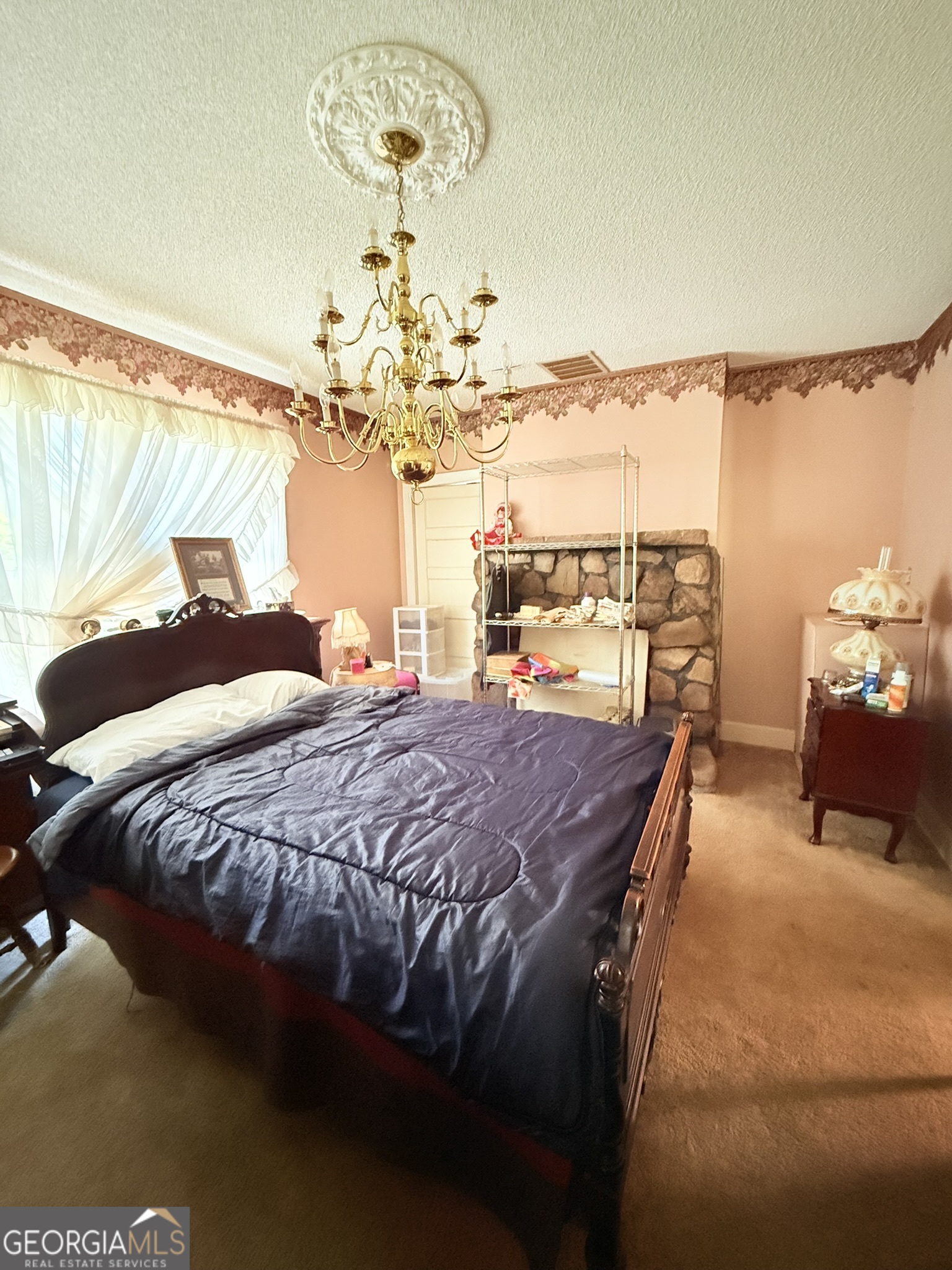51 Cedar Street Menlo, GA 30731 - Photo 57 of 86 a bedroom with a bed and chandelier