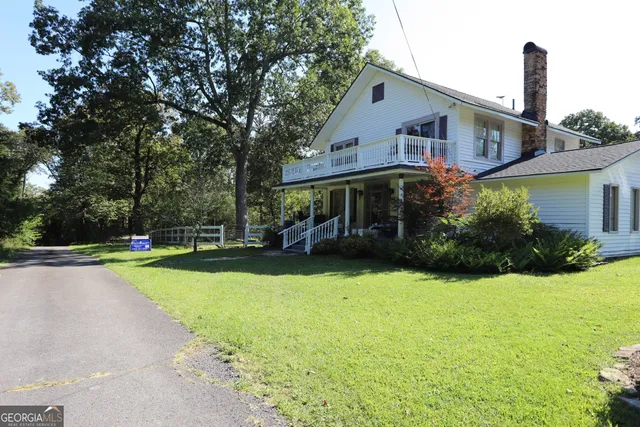 a view of a house with a yard porch and sitting area
