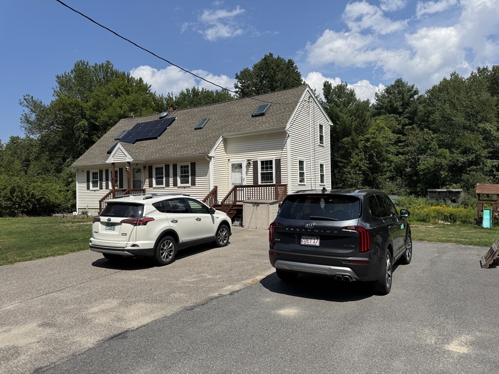 8 Heritage Road, Unit 1 Pelham, NH 03076 - Photo 2 of 13 a car parked in front of a house
