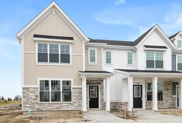 a view of a brick house with many windows