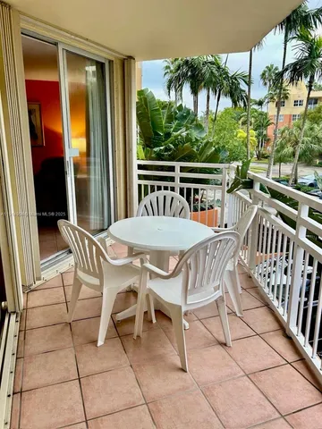 a view of a patio with a table and chairs