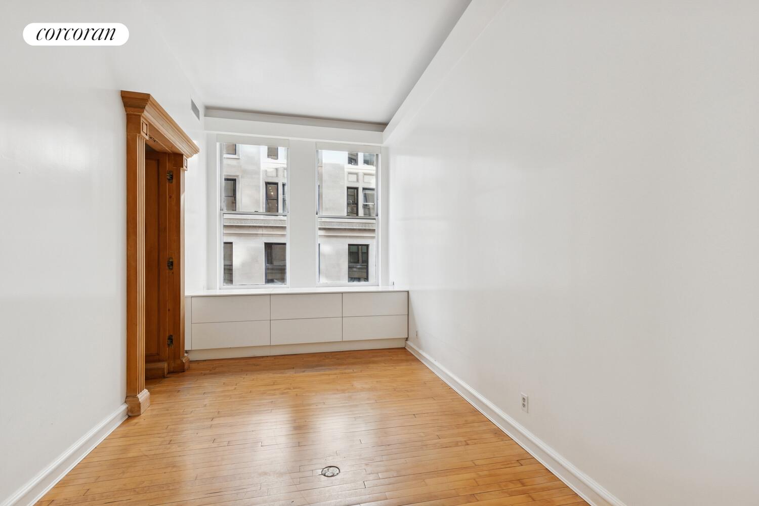 105 5th Avenue, Unit 4B Manhattan, NY 10003 - Photo 11 of 14 a view of an empty room with wooden floor and a window