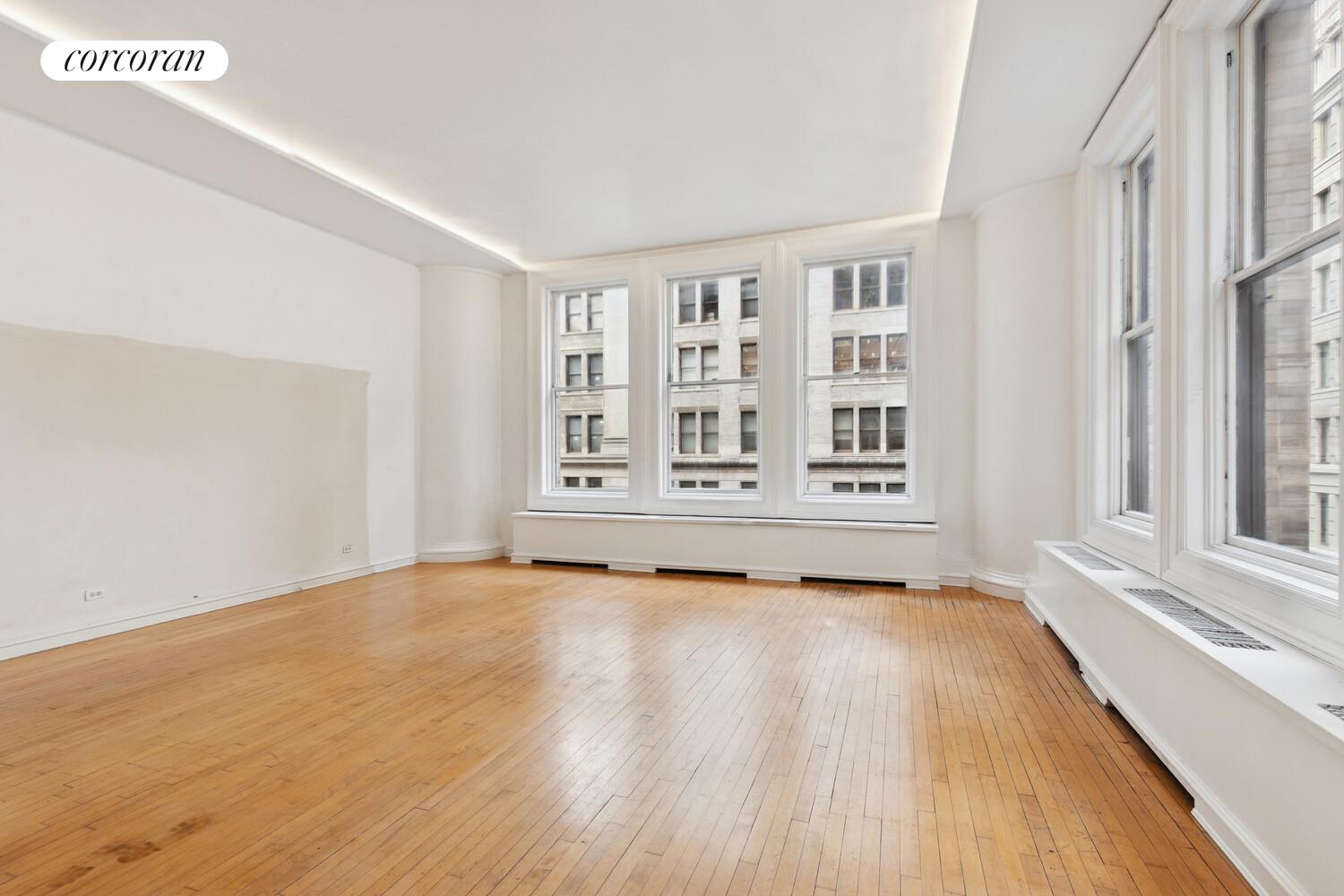 105 5th Avenue, Unit 4B Manhattan, NY 10003 - Photo 7 of 14 a view of an empty room with a window and wooden floor