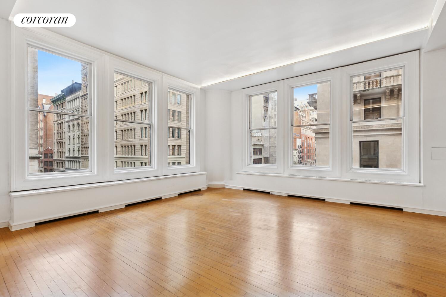 105 5th Avenue, Unit 4B Manhattan, NY 10003 - Photo 8 of 14 a view of an empty room with wooden floor and a window