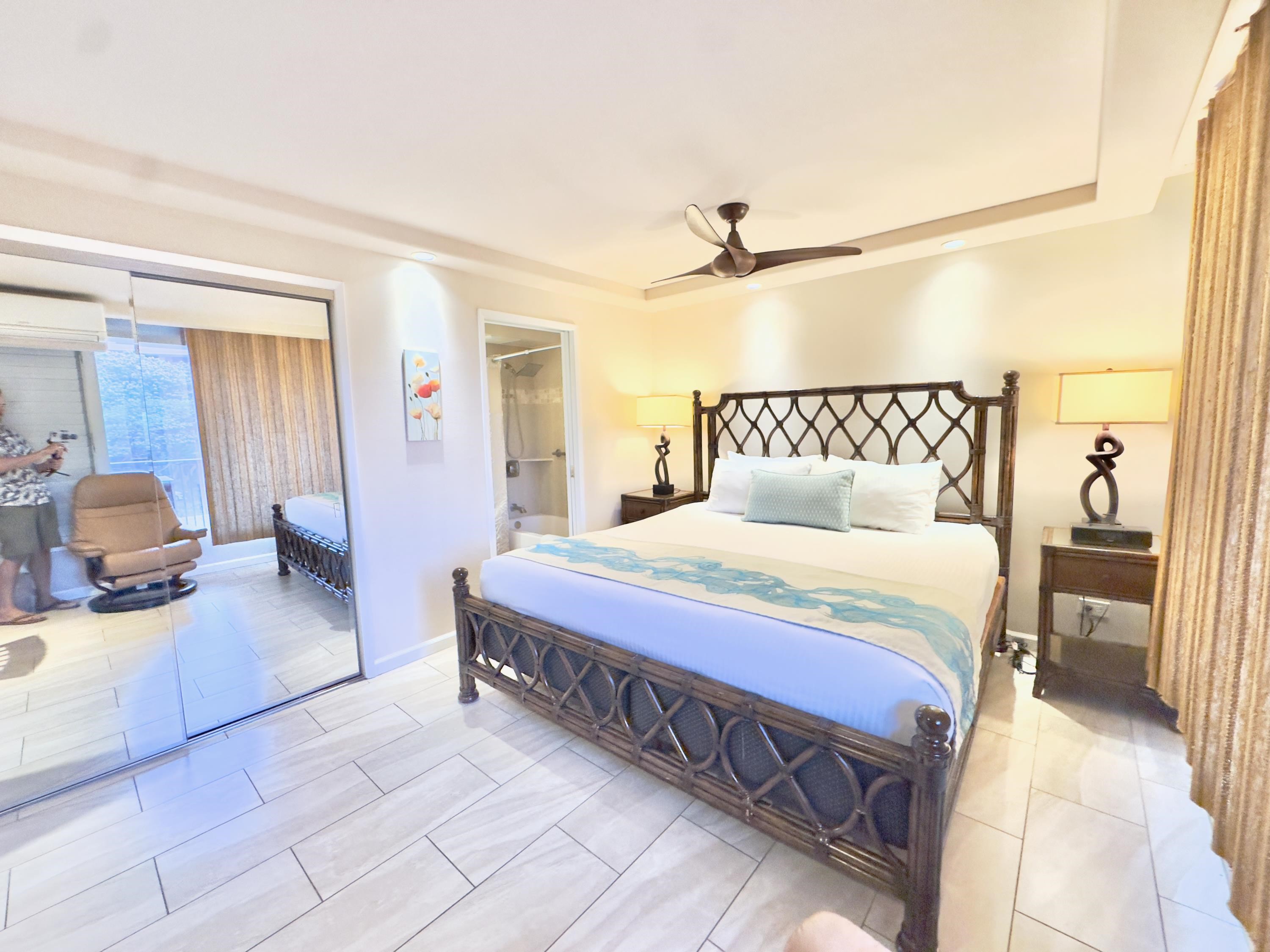 2960 South Kihei Road, Unit 209 Kihei, HI 96753 - Photo 23 of 43 a bedroom with a large bed and a chandelier