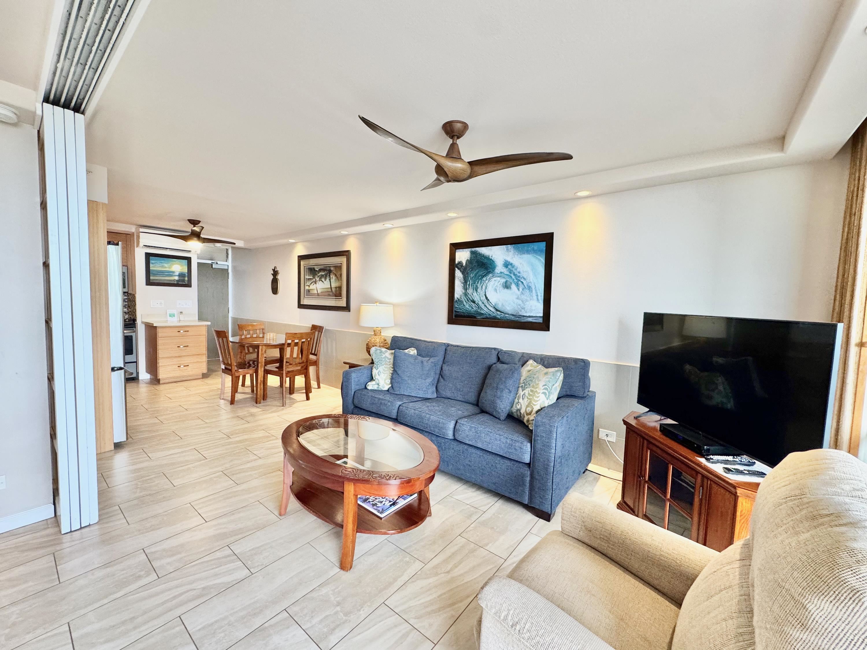 2960 South Kihei Road, Unit 209 Kihei, HI 96753 - Photo 6 of 43 a living room with furniture a flat screen tv and kitchen view