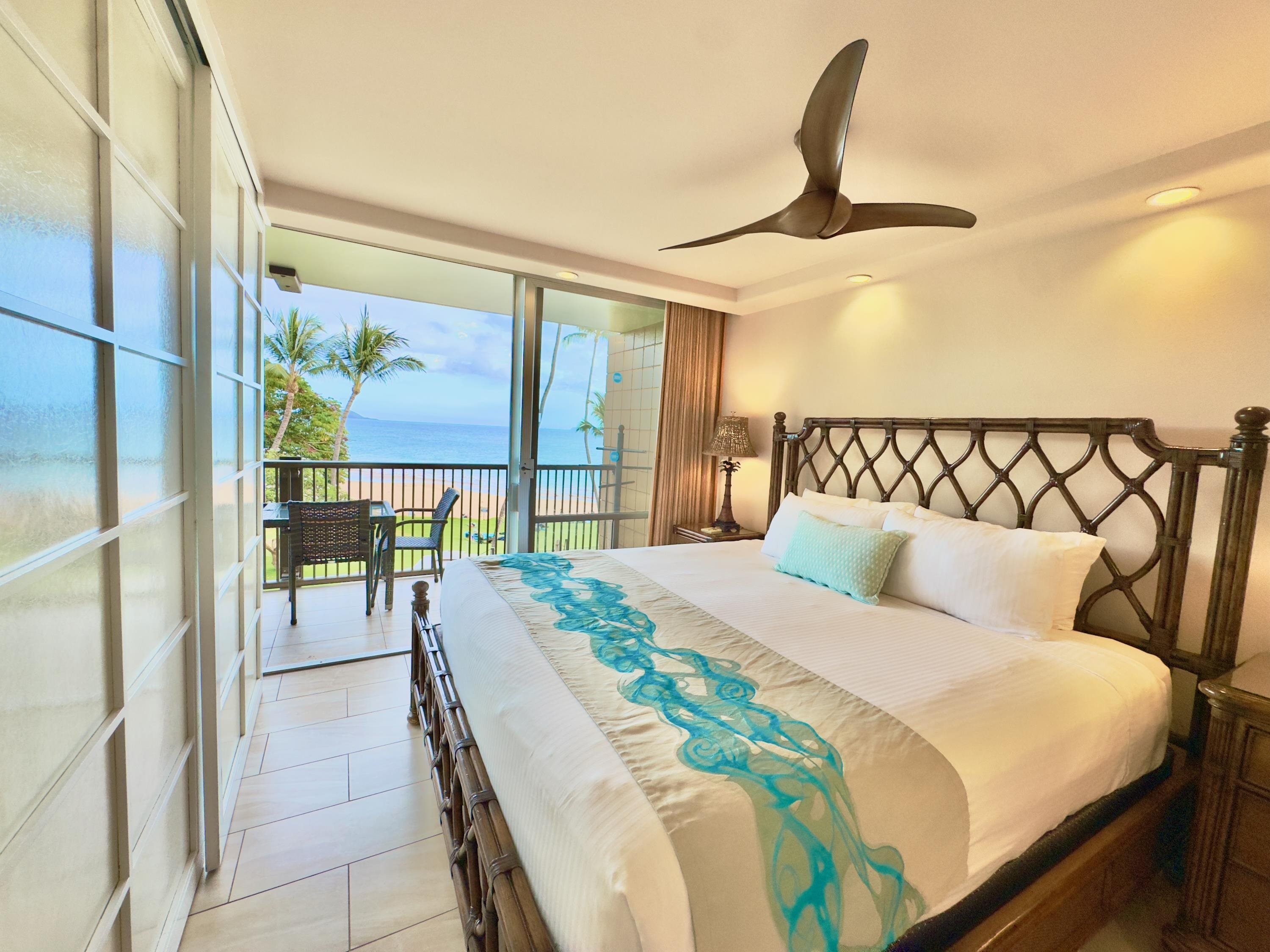 2960 South Kihei Road, Unit 209 Kihei, HI 96753 - Photo 8 of 43 a bedroom with a bed and a chandelier