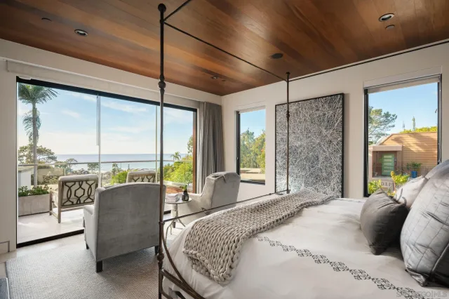 a bedroom with a large bed and a large window